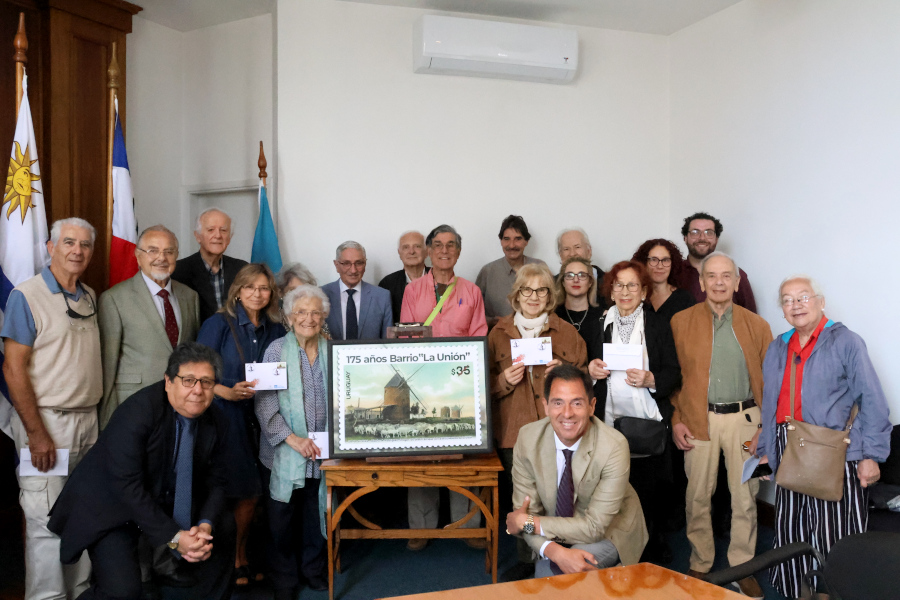 Participantes del acto junto a la reproducción del sello conmemorativo